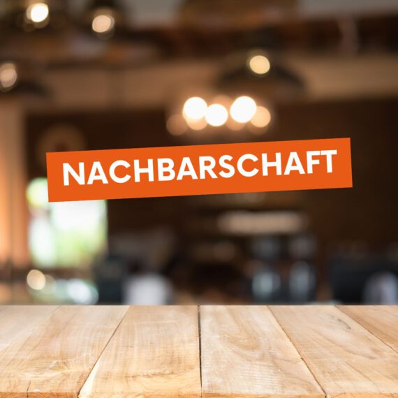 Der Text „Nachbarschaft“ steht in einem orangen Textblock. Im Hintergrund sind ein Holztisch und eine unscharfe Beleuchtung abgebildet.