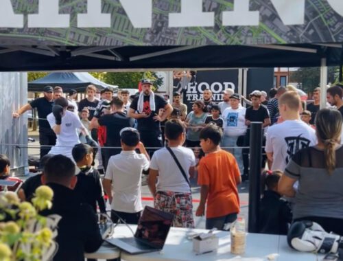 Kinder stehen draußen vor einem Boxring