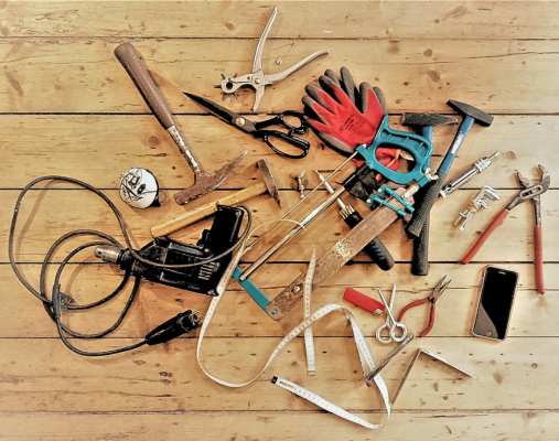 verschiedene Werkzeuge liegen auf einem Holzfußboden
